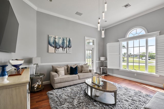 living area featuring plenty of natural light, baseboards, visible vents, dark wood-style flooring, and crown molding