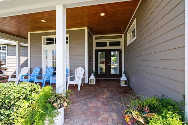 doorway to property featuring a porch and french doors