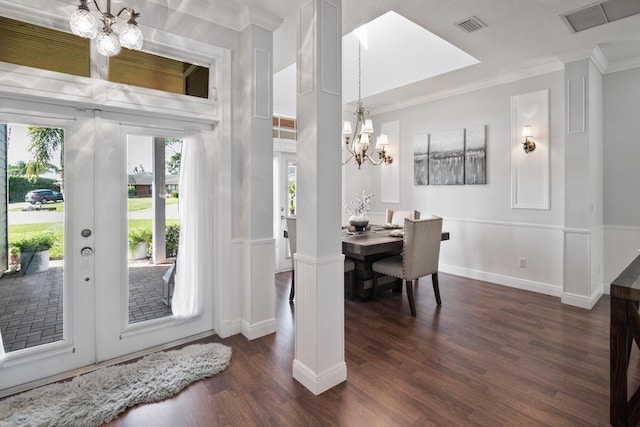 dining room with visible vents, dark wood finished floors, an inviting chandelier, crown molding, and french doors