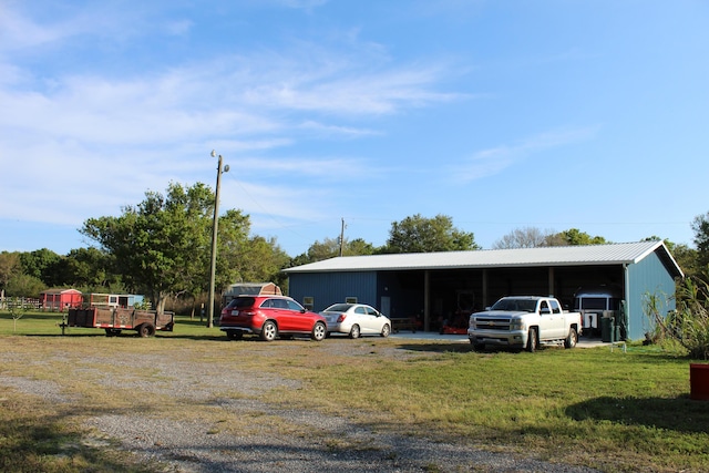 view of parking / parking lot with a pole building and a carport