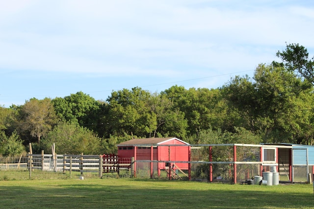 exterior space featuring fence, an outdoor structure, and exterior structure