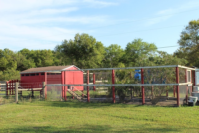 exterior space with an outbuilding, fence, and exterior structure