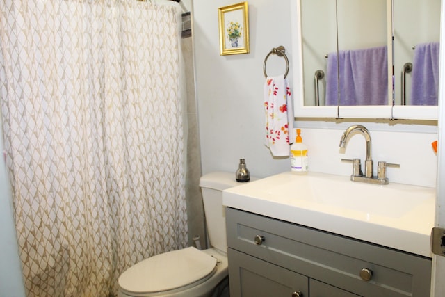 bathroom with curtained shower, vanity, and toilet