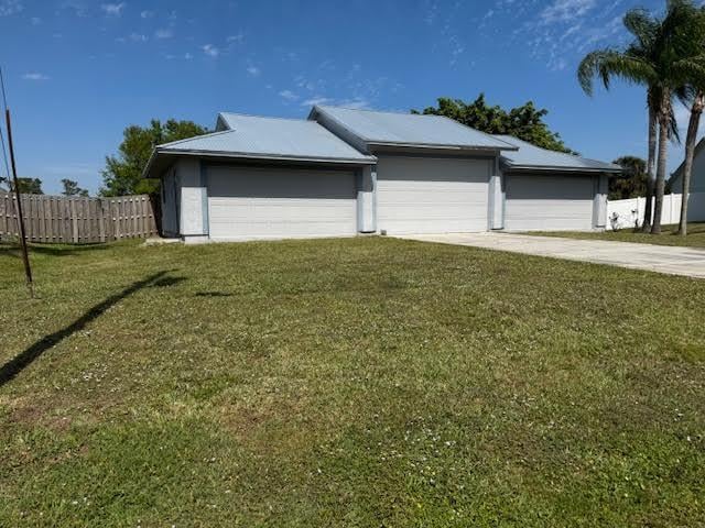 garage with driveway and fence