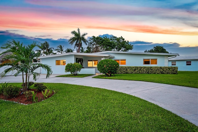 6620 Lake Clarke Dr, Lake Clarke Shores, FL 33406 - view of front facade featuring concrete driveway, a yard, and stucco siding