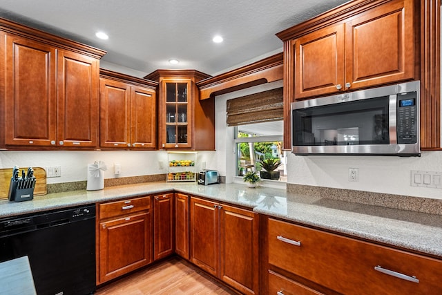 kitchen featuring recessed lighting, dishwasher, light wood finished floors, stainless steel microwave, and glass insert cabinets