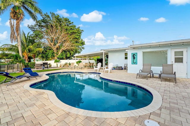 view of pool with a fenced in pool, a patio area, and fence