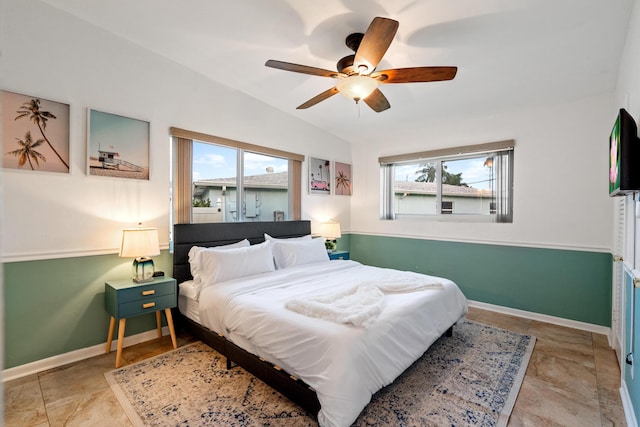 bedroom featuring ceiling fan, baseboards, and vaulted ceiling