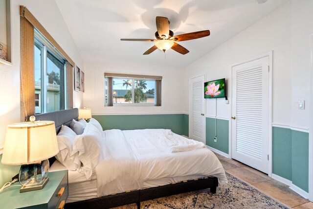 bedroom featuring ceiling fan, baseboards, and vaulted ceiling