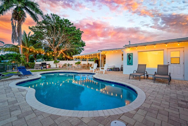 view of swimming pool featuring a fenced in pool, a patio, and fence