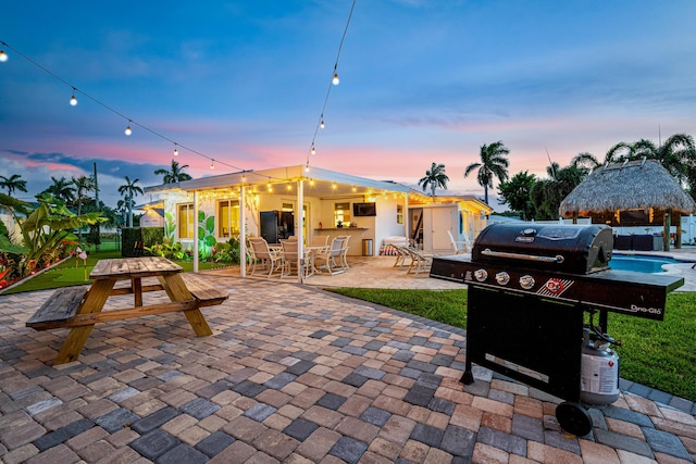 view of patio with outdoor dining area, area for grilling, and a gazebo