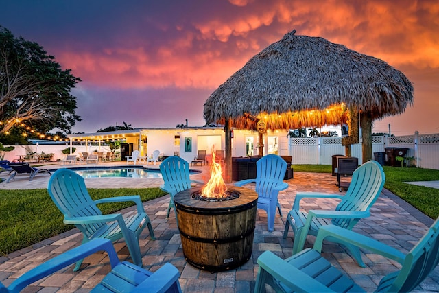 view of patio featuring a gazebo, an outdoor fire pit, fence, and a fenced in pool