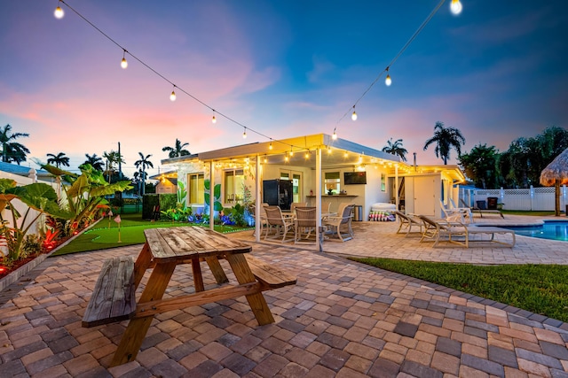 view of patio / terrace featuring a fenced in pool and fence