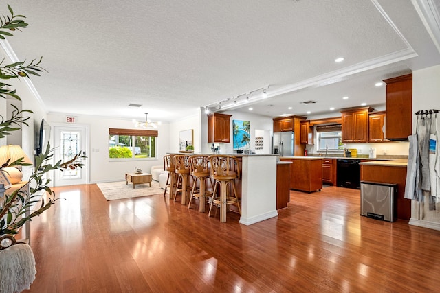 kitchen featuring a textured ceiling, black dishwasher, ornamental molding, light wood-type flooring, and stainless steel refrigerator with ice dispenser