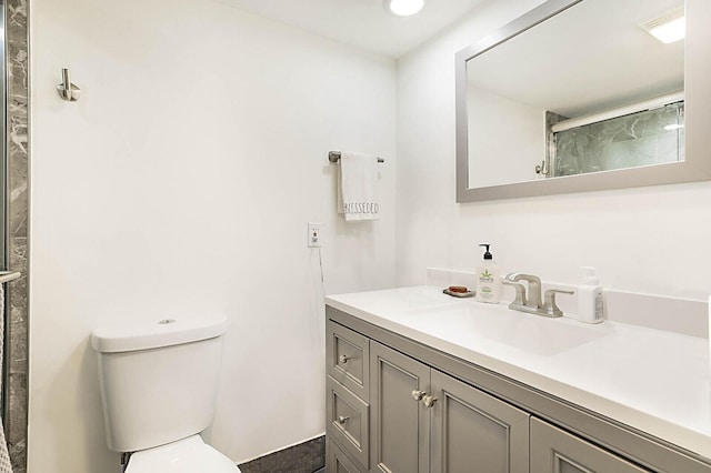 bathroom featuring an enclosed shower, toilet, and vanity