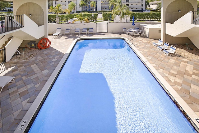 pool featuring a patio and fence