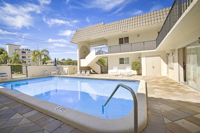 pool featuring a patio and fence