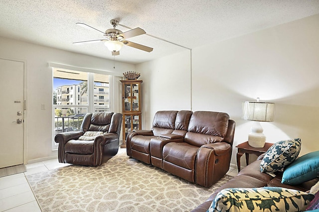 tiled living area featuring a textured ceiling and ceiling fan