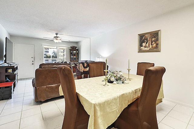 dining room with light tile patterned floors, a textured ceiling, and a ceiling fan