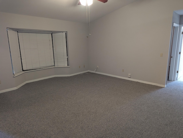 carpeted spare room featuring baseboards and ceiling fan