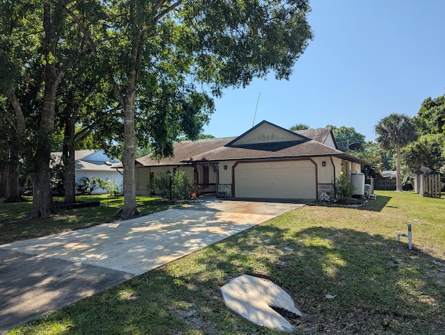 single story home featuring an attached garage, driveway, stone siding, and a front yard