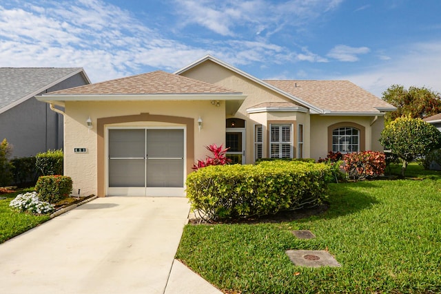 ranch-style house featuring stucco siding, driveway, roof with shingles, a front yard, and an attached garage