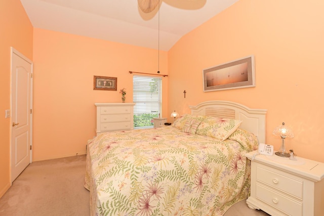 bedroom with a ceiling fan, vaulted ceiling, and light colored carpet