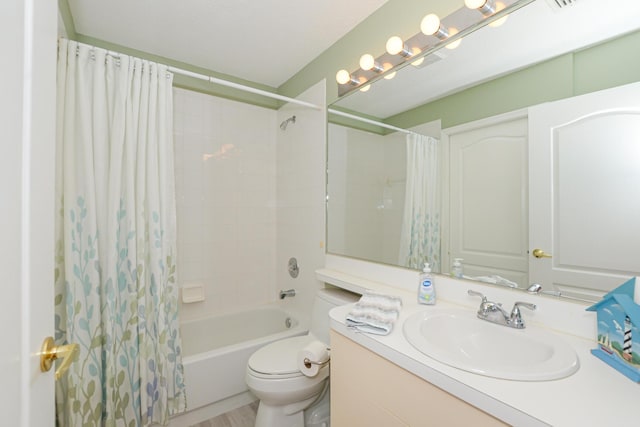 bathroom featuring toilet, vanity, and shower / bath combo