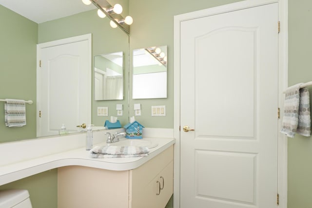 bathroom with toilet and vanity