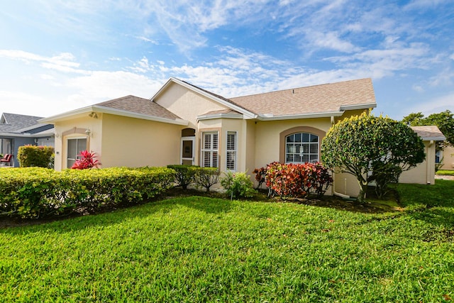 single story home with a garage, stucco siding, a shingled roof, and a front yard