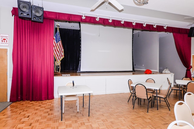 interior space with rail lighting and a ceiling fan