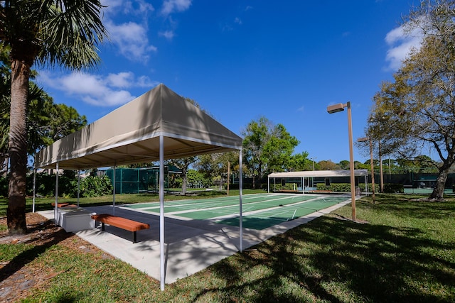 view of home's community with a lawn and shuffleboard