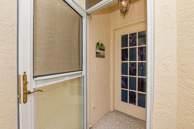 property entrance with stucco siding