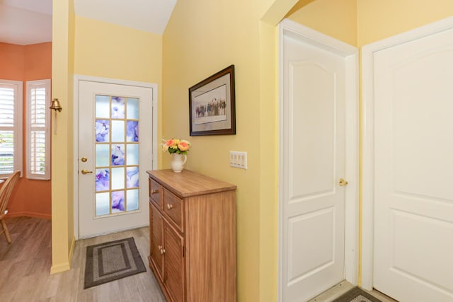 entryway with baseboards and light wood-style floors