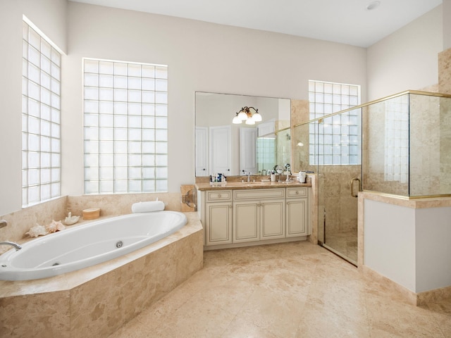 full bathroom with vanity, a shower stall, a jetted tub, and a wealth of natural light