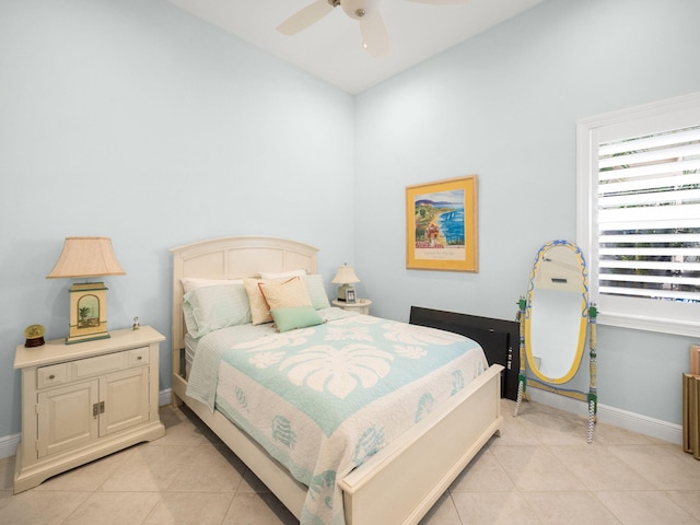 bedroom with light tile patterned flooring, ceiling fan, and baseboards