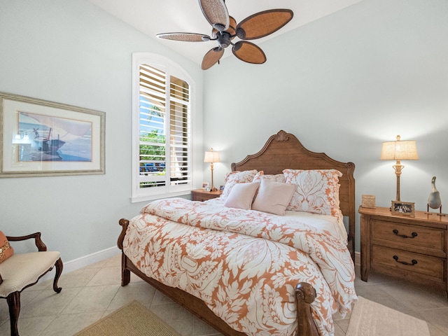 bedroom with light tile patterned floors and baseboards