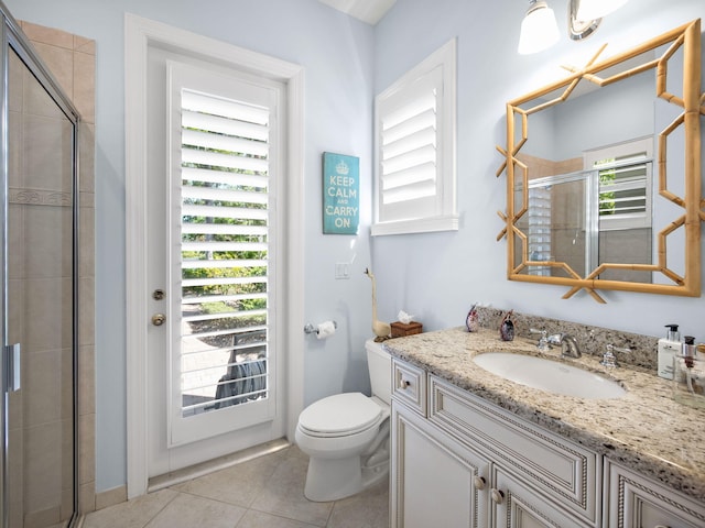 bathroom with tile patterned floors, toilet, a stall shower, and vanity