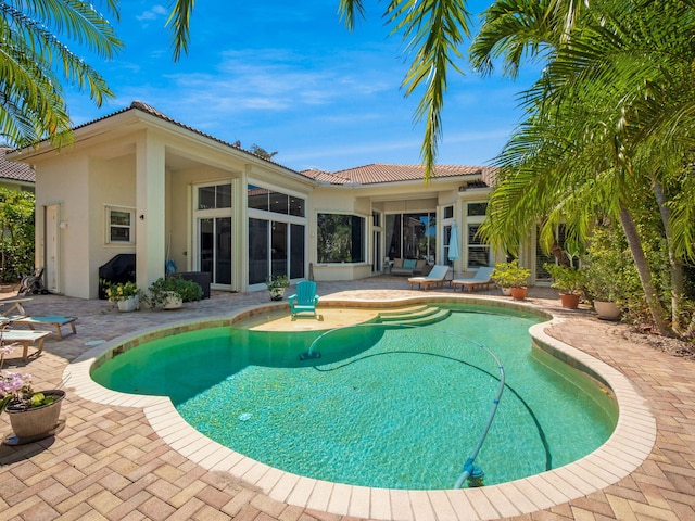 outdoor pool with a patio area