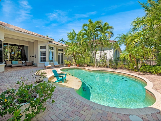 view of swimming pool with a fenced in pool, fence, and a patio area