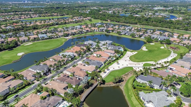 aerial view featuring a residential view, golf course view, and a water view