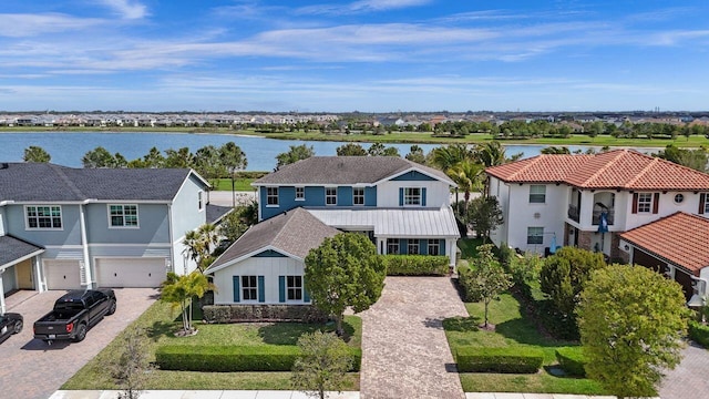 birds eye view of property with a residential view and a water view