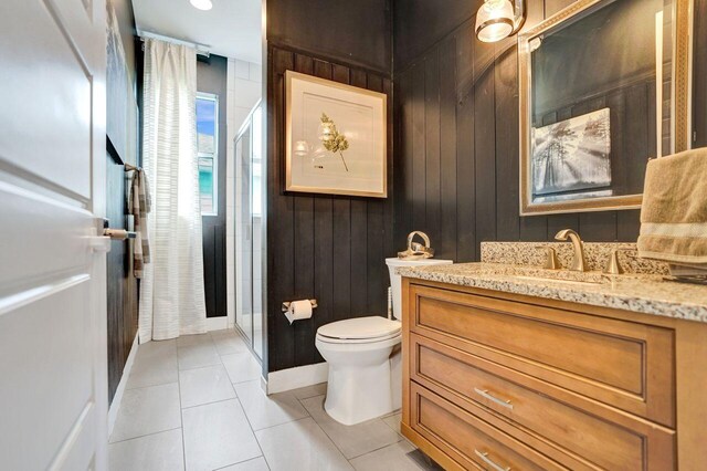 full bath with vanity, toilet, a shower stall, and tile patterned flooring