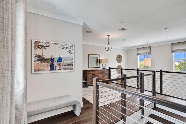 hallway featuring crown molding, wood finished floors, an upstairs landing, and recessed lighting