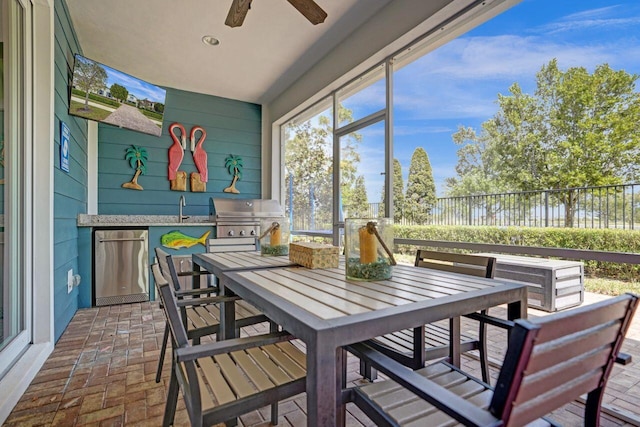 sunroom / solarium featuring ceiling fan