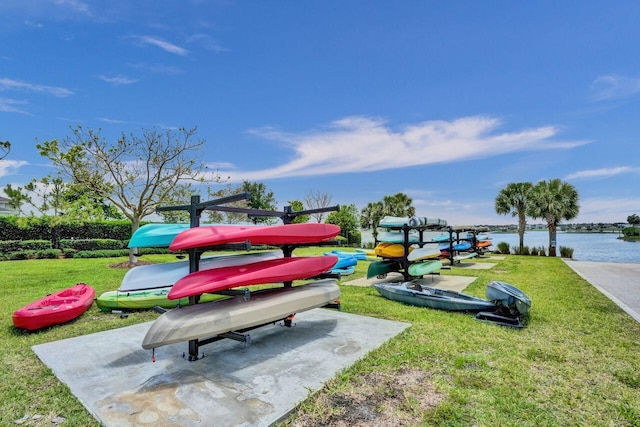 view of home's community with a yard and a water view