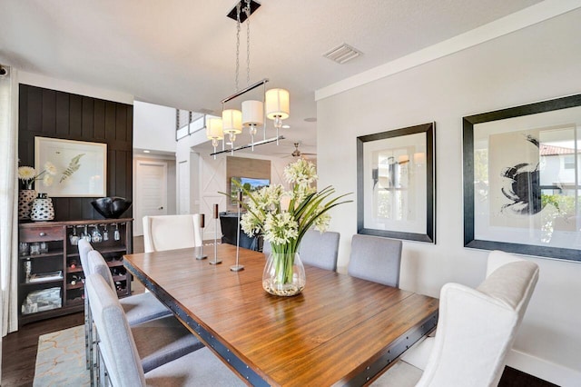 dining space featuring visible vents and wood finished floors