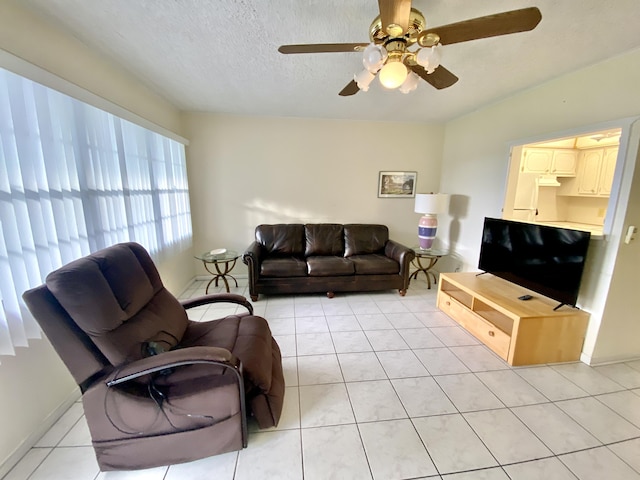 living area featuring light tile patterned floors and a textured ceiling