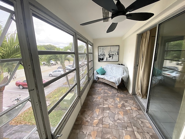 sunroom featuring ceiling fan