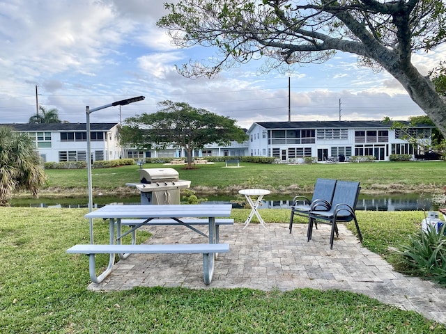 view of community featuring a patio and a yard